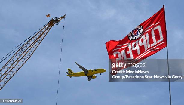 Inglewood, CA A plane flies toward Los Angeles International Airport as Los Angeles Clippers owner Steve Ballmer talks about the construction on the...