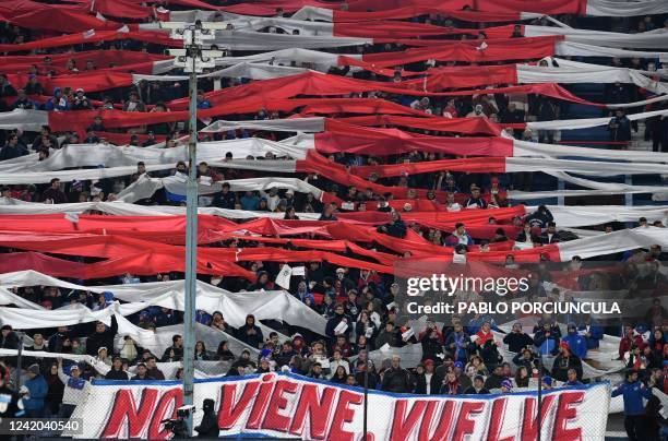 Fans of Nacional display a banner reading "He Doesn't Arrive, He Returns" as part of a campaign to try to convince Uruguayan football star Luis...