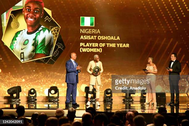Patrice Motsepe, President of African Football Confederation gives title to Asisat Oshoala of Nigeria after winning the Women's player of the Year...