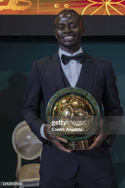 The left-winger Sadio Mane of Senegal poses with his trophy after winning the African Footballer of the Year award during the Confederation of...
