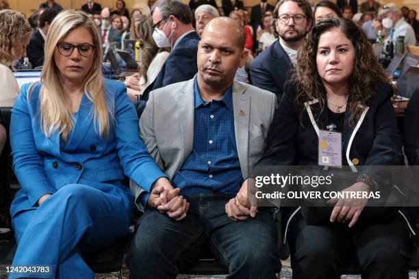 Erin Smith, the widow of DC Metropolitan Police Officer Jeffrey Smith, Capitol Police Sgt Aquilino Gonell, and Sandra Garza, the long-time partner of...