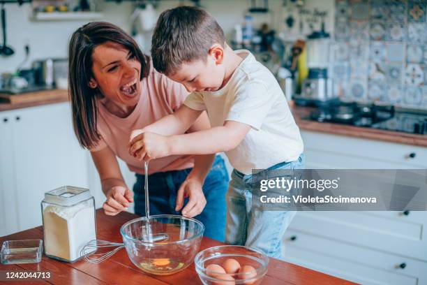 mother and son cooking together. - egg yolk stock pictures, royalty-free photos & images