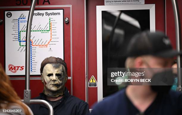 Cosplayer dressed as Michael Myers from the movies "Halloween" rides the trolley during Comic-Con International 2022 on July 21, 2022 in San Diego,...