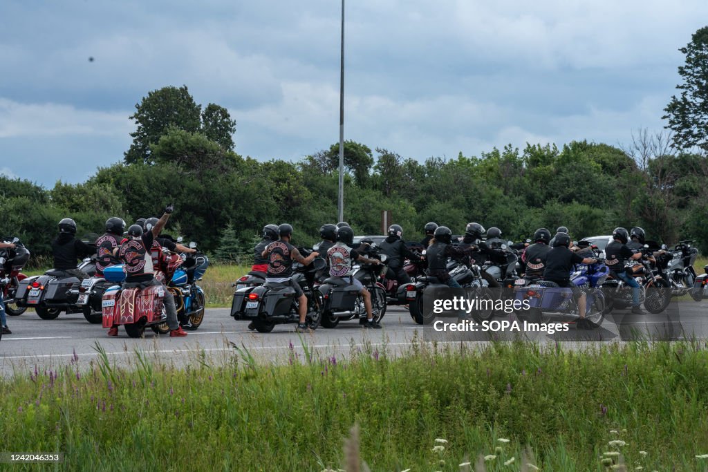 A procession of Hells Angels motorcycles along the highway...