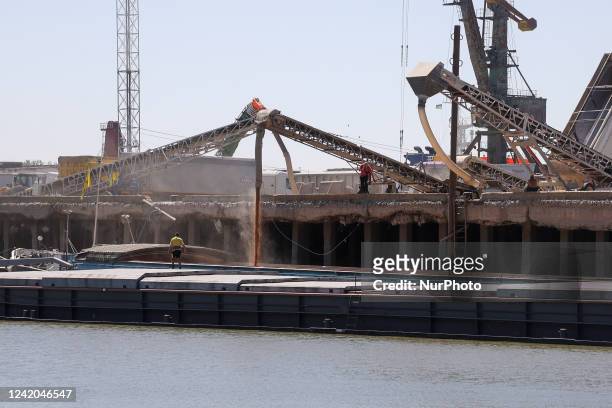 Barges are loaded with grain at Reni river port on Danube river, in Odesa region, Ukraine, July 21, 2022.