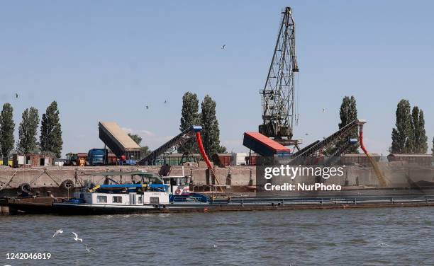 The grain is reloaded from grain carriers to barges at Reni river port on Danube river, in Odesa region, Ukraine, July 21, 2022.