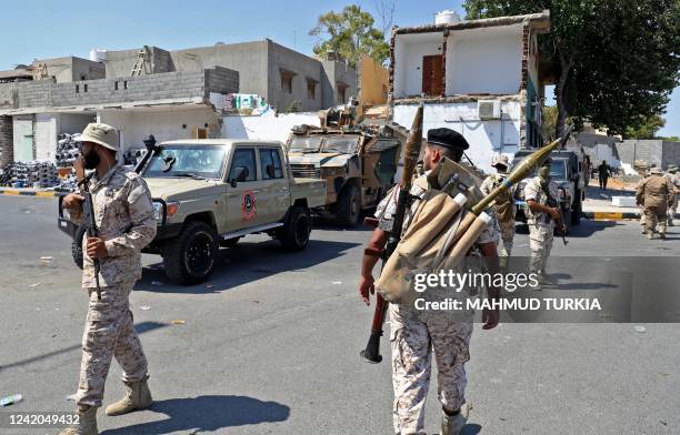 Members of the "444 Brigade" affiliated with Libya's Ministry of Defence man positions in the area of an overnight gunbattle in Tripoli's suburb of...