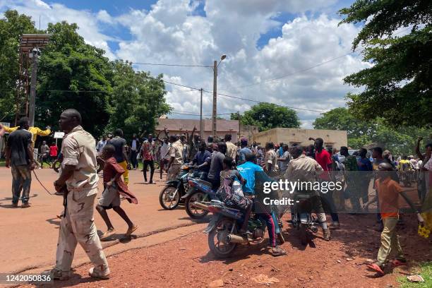 Graphic content / A crowd gathers around a man suspected of taking part in thwarted "terrorist" attack after being beaten by a crowd, in front of the...