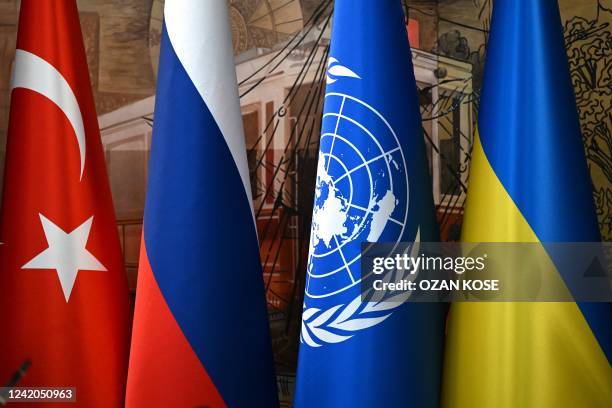 This photograph taken on July 22 shows a Turkish national flag, a Russian national flag, a United Nations flag and a Ukrainian national flag in...