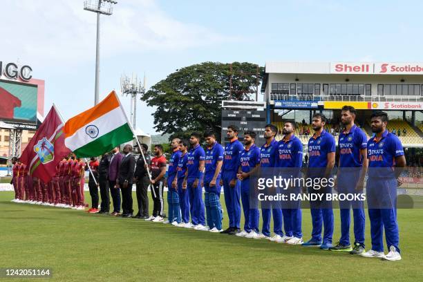 India and West Indies players stand at attention for the national anthems during the 1st ODI match between West Indies and India at Queens Park Oval,...