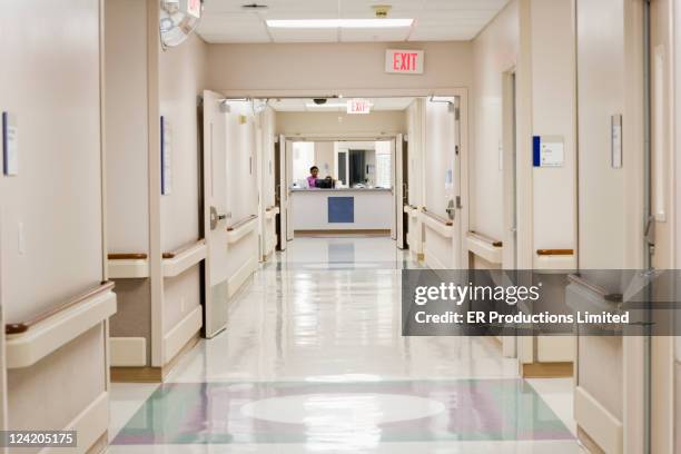 nurse working at hospital nurses station - hall stockfoto's en -beelden