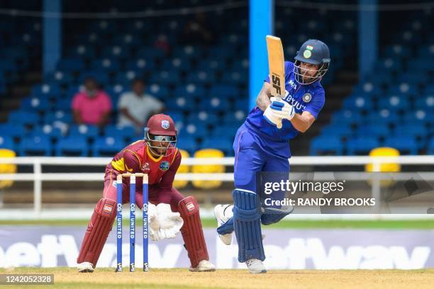 Shikhar Dhawan of India hits 4 and Nicholas Pooran of West Indies watch during the 1st ODI match between West Indies and India at Queens Park Oval,...