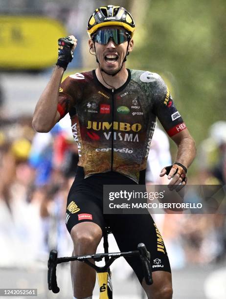 Jumbo-Visma team's French rider Christophe Laporte celebrates as he cycles to the finish line to win the 19th stage of the 109th edition of the Tour...