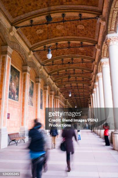 people walking underneath ornate portico - baden baden stock pictures, royalty-free photos & images