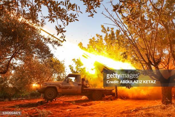Syrian opposition fighters in Jabal al-Zawiya region in the south of Syria's rebel-held Idlib province, launch rockets toward regime positions, on...