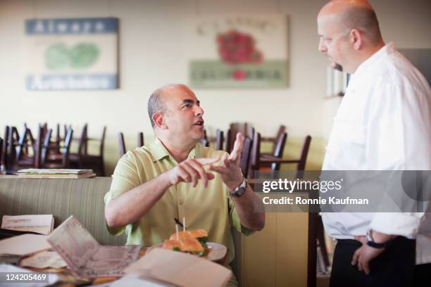 angry customer complaining to chef in restaurant - complaining stock-fotos und bilder