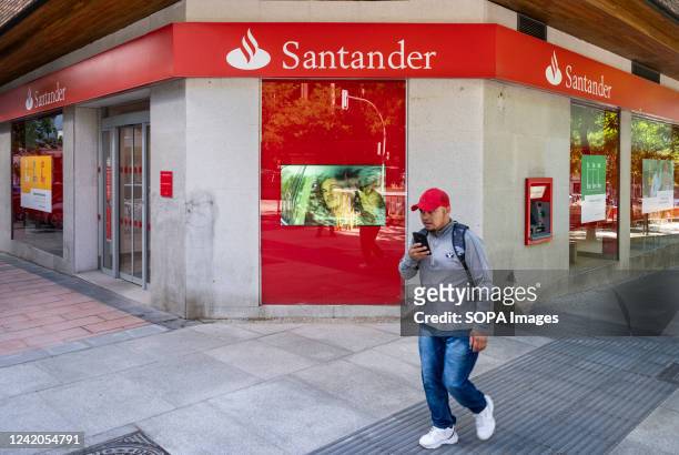 Pedestrian walks past the Spanish multinational commercial bank and financial services of Santander branch seen in Spain.