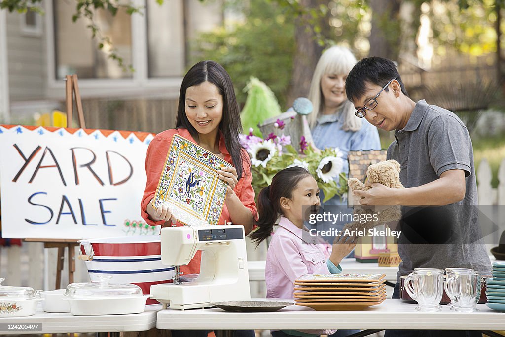 Asian family shopping at yard sale