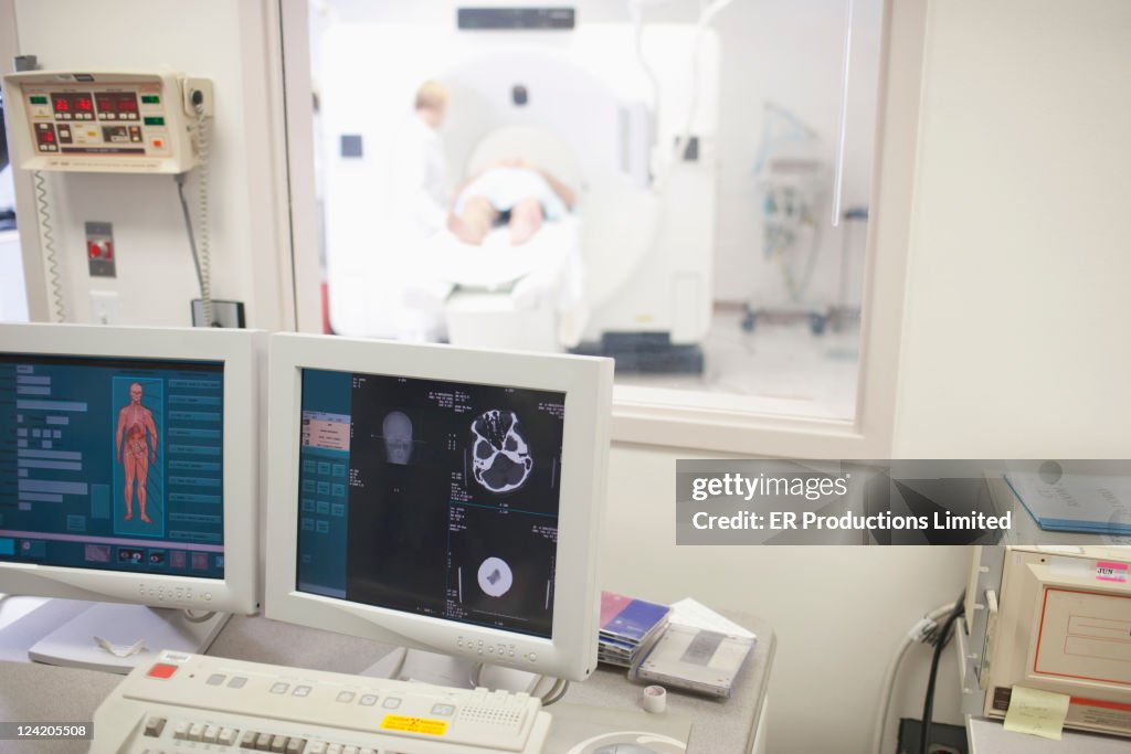 Computer Mri Scanner Computer Monitors With Mri Scanner In Background High-Res Stock Photo ...