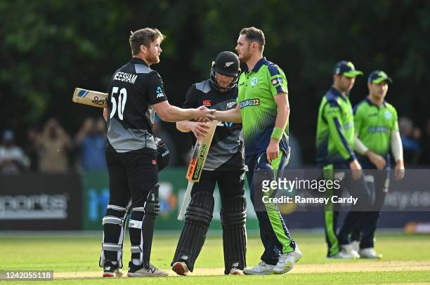 Belfast , United Kingdom - 22 July 2022; Jimmy Neesham of New Zealand and Mark Adair of Ireland shake hands after the Men's T20 International match...
