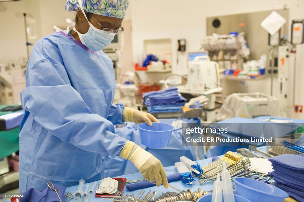 Black doctor working in operating room