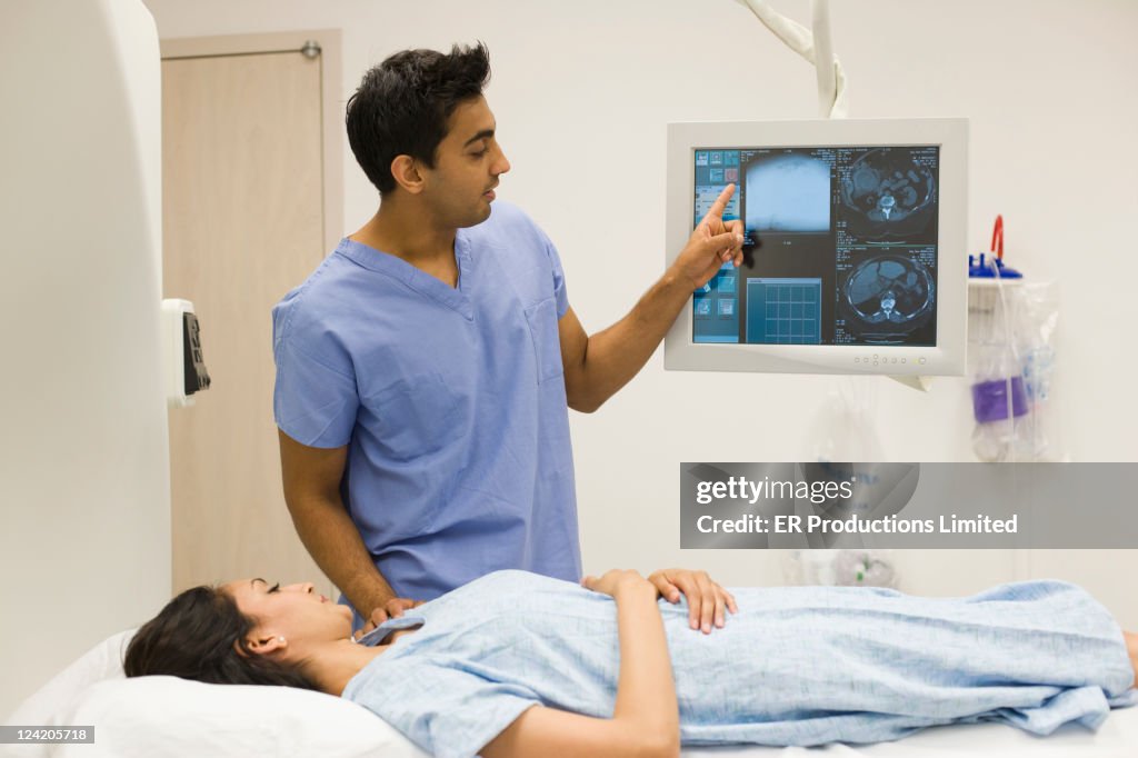Nurse talking to patient laying on MRI scanner