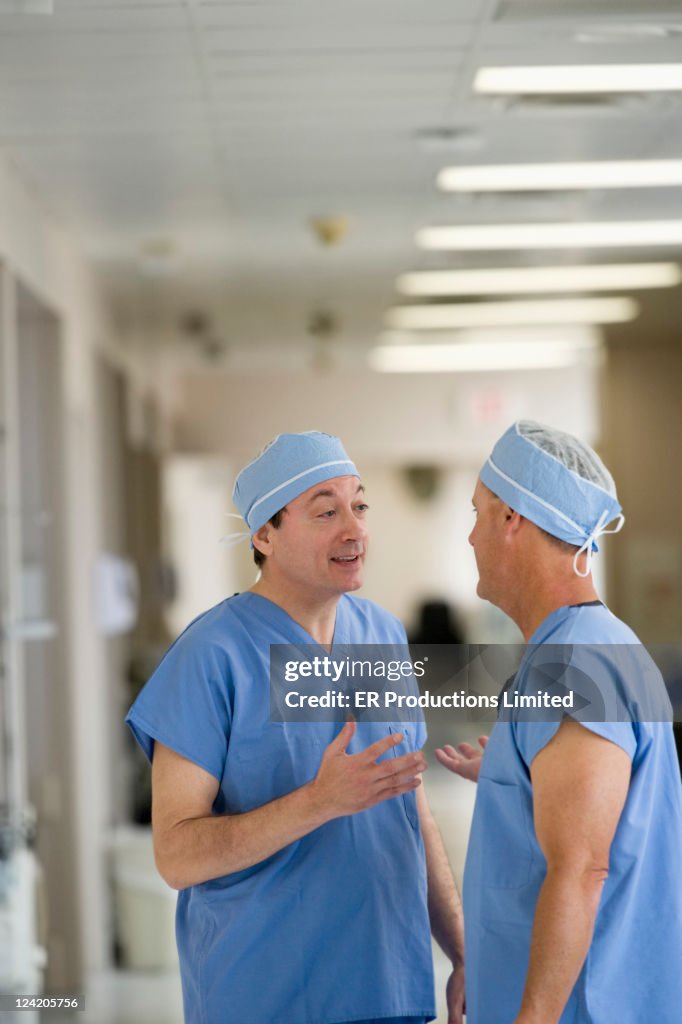 Doctors talking in hospital corridor