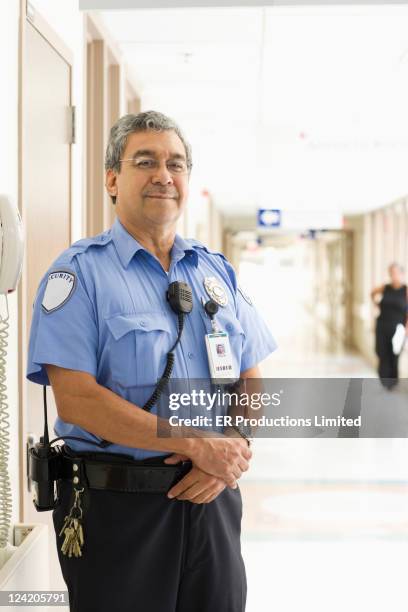 wachmann stehend im krankenhaus-korridor - security guard stock-fotos und bilder