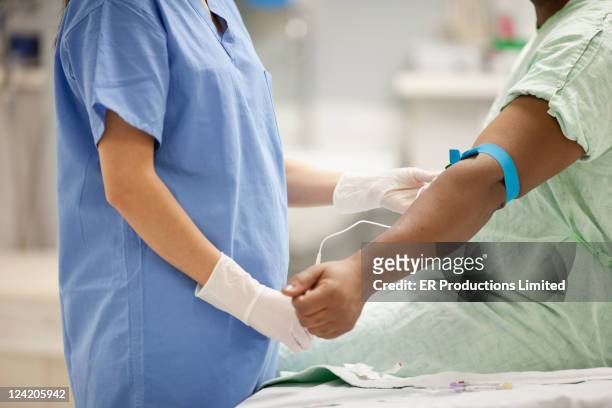 nurse taking blood from patient in hospital - blood drive stock pictures, royalty-free photos & images