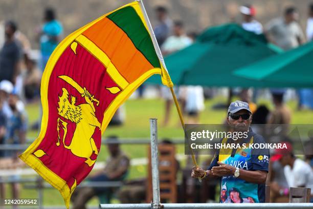 In this photograph taken on July 19 Sri Lanka's cricket fan Percy Abeysekera watches the fourth day play of the first cricket Test match between Sri...