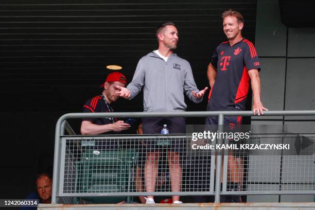 Bayern Munich head coach Julian Nagelsmann chats with Green Bay Packers head coach Matt LaFleur as they watch Manchester City FC training session...