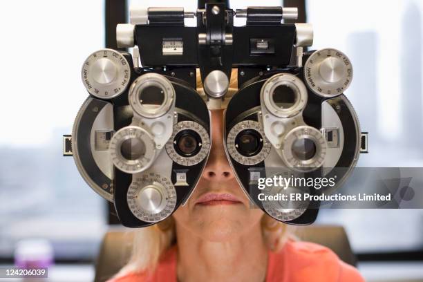 caucasian woman having eye exam - phoroptor stock pictures, royalty-free photos & images