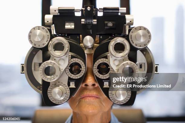 caucasian woman having eye exam - eye test equipment stock pictures, royalty-free photos & images