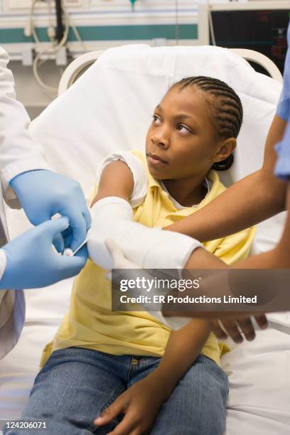 doctor and nurse putting cast on boy's arm in hospital - wrapping arm stock pictures, royalty-free photos & images