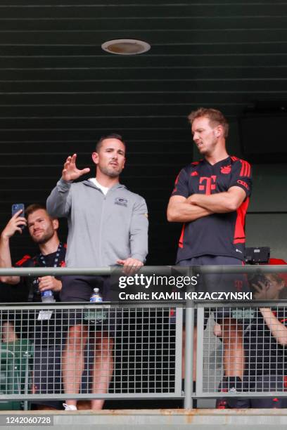 Bayern Munich head coach Julian Nagelsmann chats with Green Bay Packers head coach Matt LaFleur as they watch Manchester City FC training session...