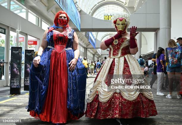 Spiderman and Iron Man inspired princess cosplayers pose in the convention center lobby during Comic-Con International 2022 on July 22, 2022 in San...