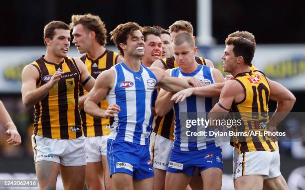 Players wrestle during the 2022 AFL Round 19 match between the North Melbourne Kangaroos and the Hawthorn Hawks at Blundstone Arena on July 23, 2022...