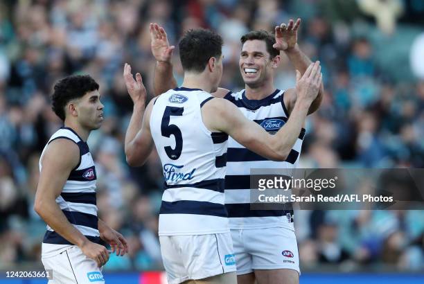 Jeremy Cameron of the Cats celebrates a goal with Tom Hawkins and Tyson Stengle during the 2022 AFL Round 19 match between the Port Adelaide Power...