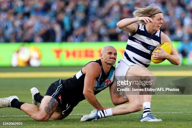 Sam Powell-Pepper of the Power tackles Zach Guthrie of the Cats during the 2022 AFL Round 19 match between the Port Adelaide Power and the Geelong...