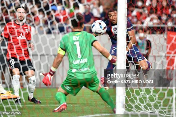 Paris Saint-Germain's French forward Kylian Mbappe scores a goal past Urawa Reds' Japanese goalkeeper Shusaku Nishikawa during PSG's Japan Tour...