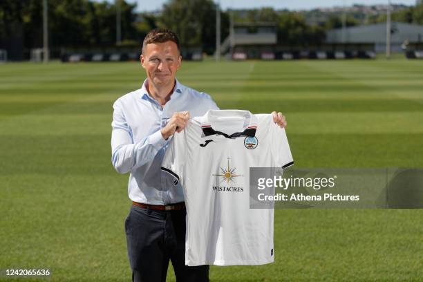 Andy Goldie poses for a portrait while holding a home shirt during the announcement of him being named as the new Academy Manager by Swansea City at...