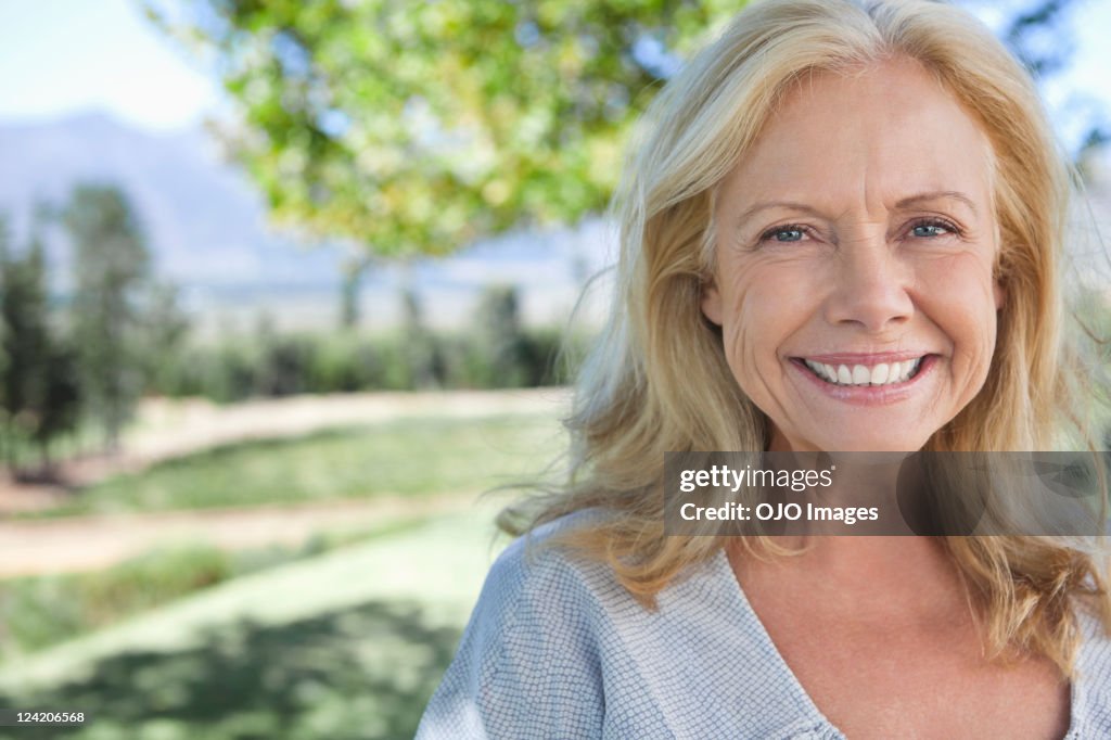 Portrait of smiling mature woman in park