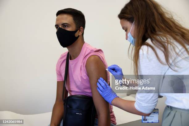 Doctor, Molly Dickinson administers a dose of the monkeypox vaccine to Arthur Macedo, 37 on July 23, 2022 in London, England. The NHS is expanding...