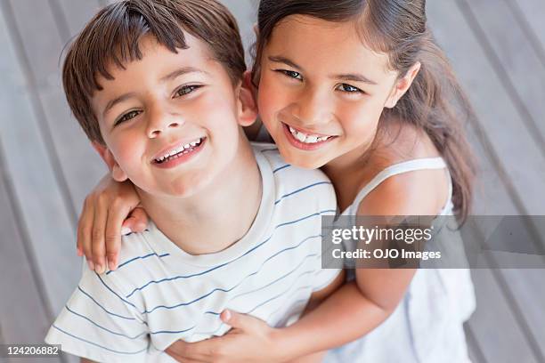 portrait of brother and sister smiling - brother sister stock pictures, royalty-free photos & images