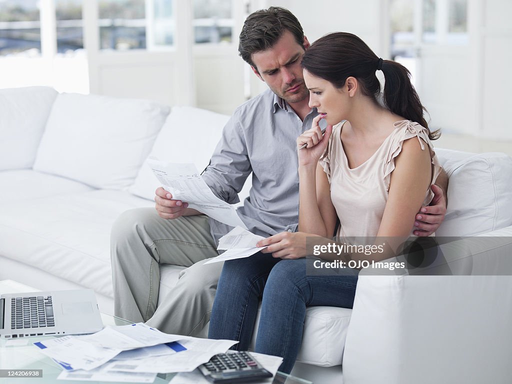 Worried mid adult couple planning home finance