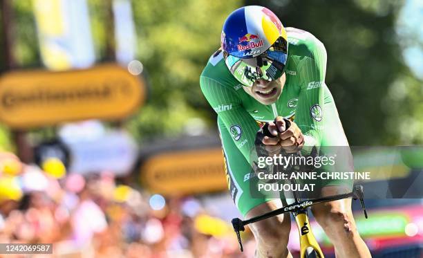 Jumbo-Visma team's Belgian rider Wout Van Aert wearing the sprinter's green jersey cycles to the finish line during the 20th stage of the 109th...