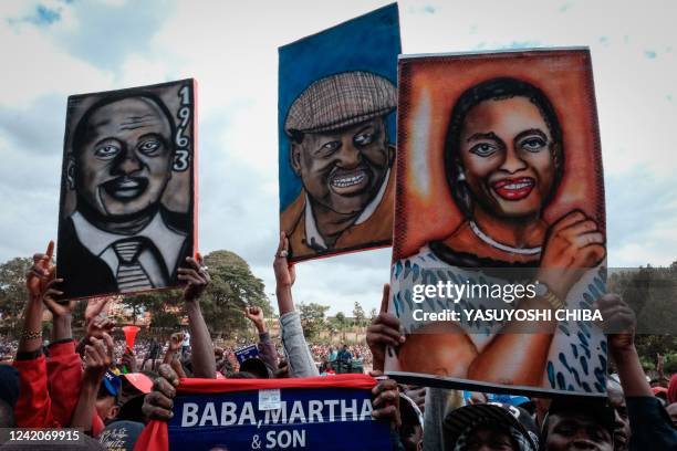 Supporters hold painted portraits of Kenya's President Uhuru Kenyatta , Azimio La Umoja Coalition presidential candidate Raila Odinga and running...