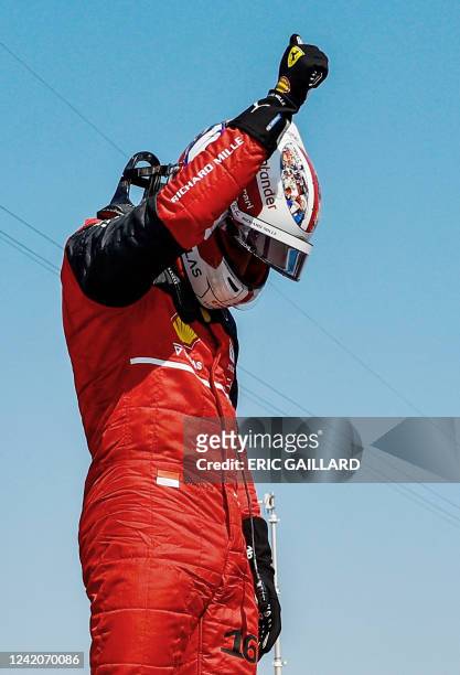 Ferrari's Monegasque driver Charles Leclerc reacts after he took the pole position during the qualifying session ahead of the French Formula One...