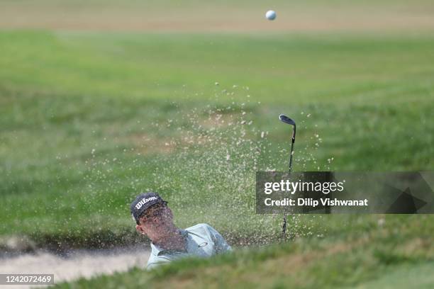 John Augenstein hits out of the bunker on the first hole during the third round of the Price Cutter Charity Championship presented by Dr Pepper at...