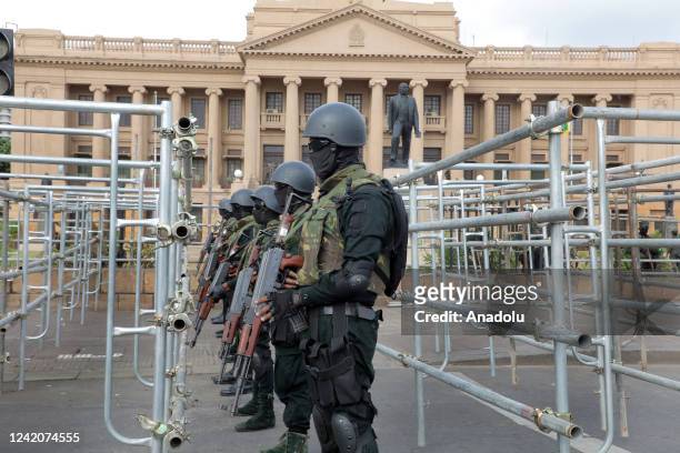 Fully armed soldiers on guard behind iron barricades across the road in front of the Presidential Secretariat premises at Galle Face in Colombo, Sri...